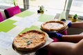 Pizza with tomatoes, mozzarella cheese, basil. Waiter with gloves takes out margarita pizza