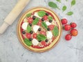 Pizza, tomatoes, olives mediterranean on concrete background preparation