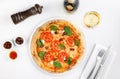 Pizza, tomatoes, olives, white wine on white background, top view