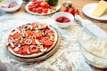 Pizza and various ingredients on table Royalty Free Stock Photo