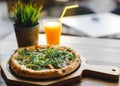 Pizza vegetable on wooden plate with orange juice. Royalty Free Stock Photo