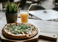 Pizza vegetable on wooden plate with orange juice. Royalty Free Stock Photo