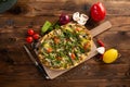 Pizza with vegetables and truffle oil on wooden background Royalty Free Stock Photo