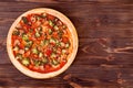 Pizza with veggie vegetables on bamboo bottom, on wooden table