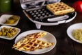 Pizza waffles, piffle. Waffles stuffed with sausage, cheese, tomatoes on a plate Royalty Free Stock Photo