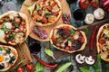 Pizza and wine party. Homemade rustic pizzas and raw ingredients