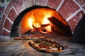 Pizza in a wood burning oven Royalty Free Stock Photo