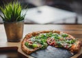Pizza on wooden plate . Royalty Free Stock Photo