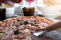 Pizza on wooden plate on table Royalty Free Stock Photo