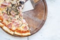 Pizza on wooden plate on table Royalty Free Stock Photo