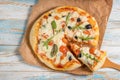 Pizza on a wooden table top view.