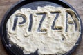Pizza word written on the flour