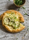 Pizza with zucchini, onion, cheese and sesame seeds