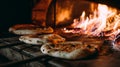 Pizzas baking in a wood-fired oven with flames adding authenticity and warmth. The pizzas display delicious toppings Royalty Free Stock Photo