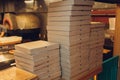 Pizzas cardboard boxes for shipping and delivery. a lot of packaging is on the kitchen stock.