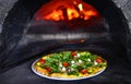 Pizzeria background. Pizza, wine glass, stone stove and chef in italian restaurant.