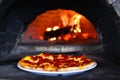 Pizzeria background. Pizza, wine glass, stone stove and chef in italian restaurant.