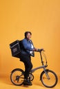 Pizzeria worker carrying food delivery thermal backpack standing riding bike