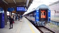 PKP Intercity Polish train sleeping car at station platform awaiting departure in late afternoon Royalty Free Stock Photo