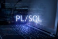 PL/SQL inscription against laptop and code background. Learn pl/sql programming language, computer courses, training Royalty Free Stock Photo