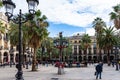 Placa Reial, shaded by palms and cooled by a fountain. Colorful lamp posts known as GaudÃÂ¬ first opera in the center. Barcelona