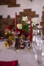 Inscription No. 2 on a stone tablet, red candles, a bouquet of red roses, white peonies and hop cones Royalty Free Stock Photo