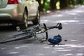 The place of the break. Bicycle and silver colored car accident on the road at forest at daytime Royalty Free Stock Photo