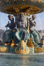 Place de la Concorde fountain statues with golden details in a sunny day in Paris, France