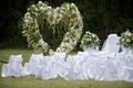 Place decorated for the wedding ceremony with heart arch from white flowers. Outdoors setup Royalty Free Stock Photo