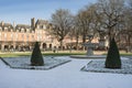 Place des Vosges is one of the oldest planned squares in Paris, lined with trees and red brick houses, built by Henri IV in 1612. Royalty Free Stock Photo