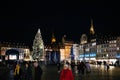 Place Kleber at night admiring the Christmas tall fir tree Notre-Dame Cathedral