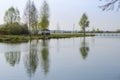 A place for meditation-wooden gazebo stands on the shore of the Lake near the young trees Royalty Free Stock Photo