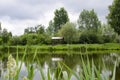 A place for meditation-wooden gazebo stands on the shore of the Lake near the young trees Royalty Free Stock Photo