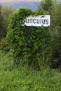 White sign on the side of the road with the name of the locality, Suncuius. Bihor county, Romania, Europe