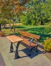 Wooden seat in a city park. Picnic in the park. Rest in the open area. Wooden picnic table and seats Royalty Free Stock Photo