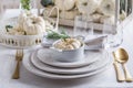 Place setting for Thanksgiving with small white pumkin and rosemary in white Royalty Free Stock Photo