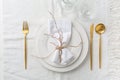 Place setting in white - plates, cutlery in gold, napkin Royalty Free Stock Photo