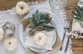 Place setting on a wooden table with white mini pumpkins, sage leaves and crystal glasses Royalty Free Stock Photo