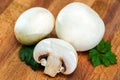 Place the sliced and whole edible, delicious porcini mushrooms and parsley on a wooden cutting Board