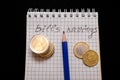 place for text, notebook, graph with pen and euro coins. Close-up of a pen and euro coins on top of a financial graph