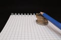 place for text, notebook, graph with pen and euro coins. Close-up of a pen and euro coins on top of a financial graph Royalty Free Stock Photo