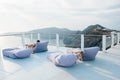 A place to relax with blue soft armchairs overlooking the sea and the mountains on Santorini