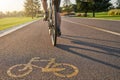 Place to train. Close up of a bicycle sign drawn on asphalt. Professional male cyclist riding a road bike on a cycle