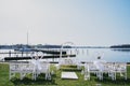 Place Venue for the wedding ceremony by the sea. white chairs and solemn arch before the wedding Royalty Free Stock Photo