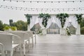 Place for wedding ceremony with wedding arch decorated with palm leaves, orchid flowers and floral peacocks. Royalty Free Stock Photo