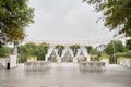 Place for wedding ceremony with wedding arch decorated with palm leaves, orchid flowers and floral peacocks and white chairs Royalty Free Stock Photo