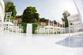 Place of wedding ceremony. Wedding decor, , details of wedding arch, floristics, chairs and a path of mirror white