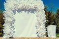 Place for wedding ceremony with white arch outdoors. Empty space.