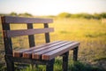 A lone bench in a field in the middle of the UK taken during a low sunset