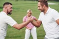 Place your bets. Side photo of two men holding the hands and showing strong friendship Royalty Free Stock Photo